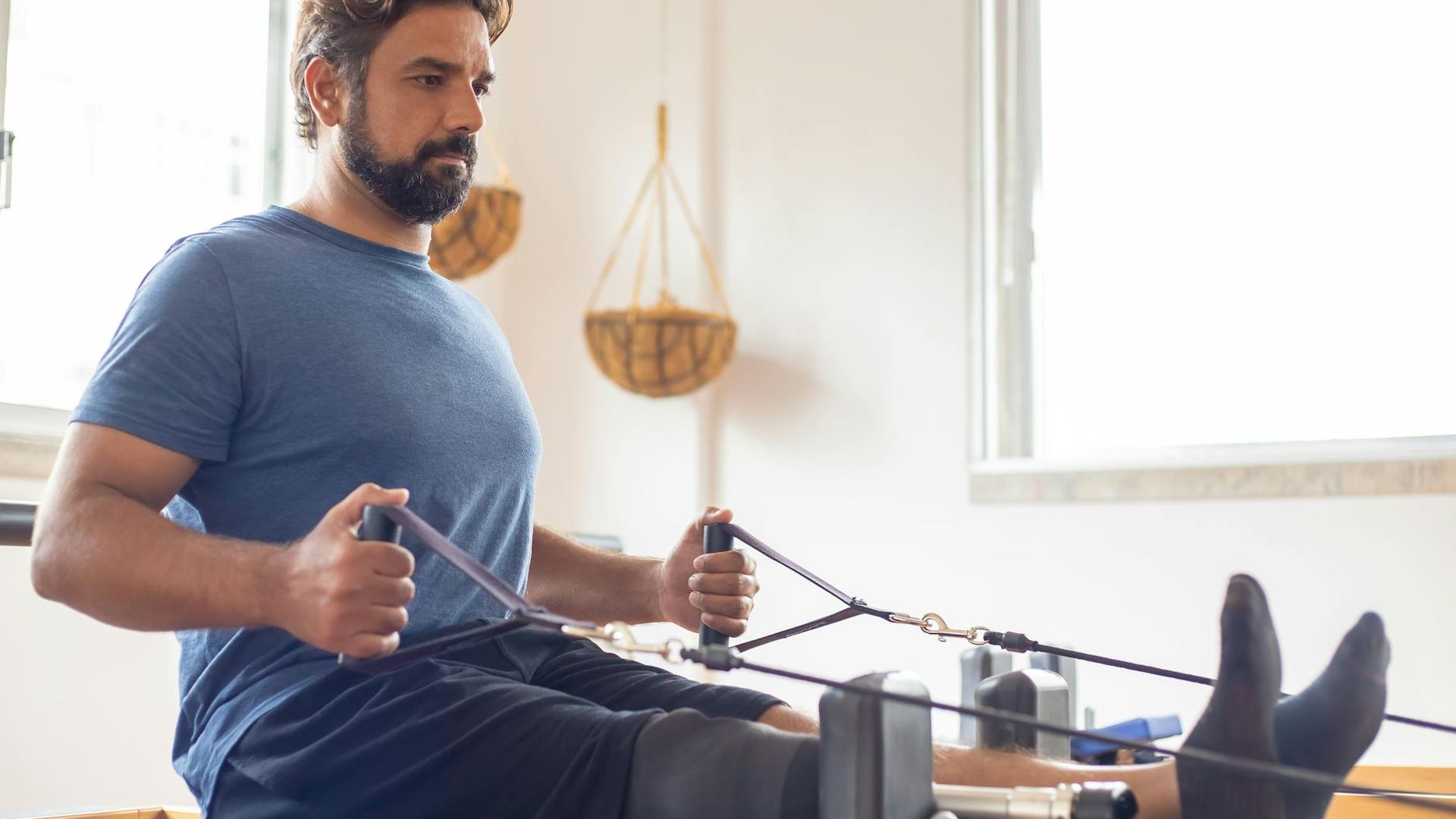 Man focusing during a calm strength session in a minimalist room