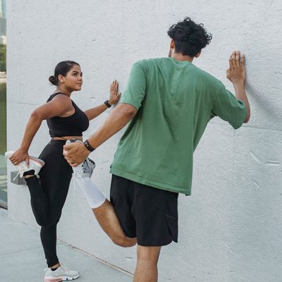 Shadow of a man doing stretching exercises on a wall